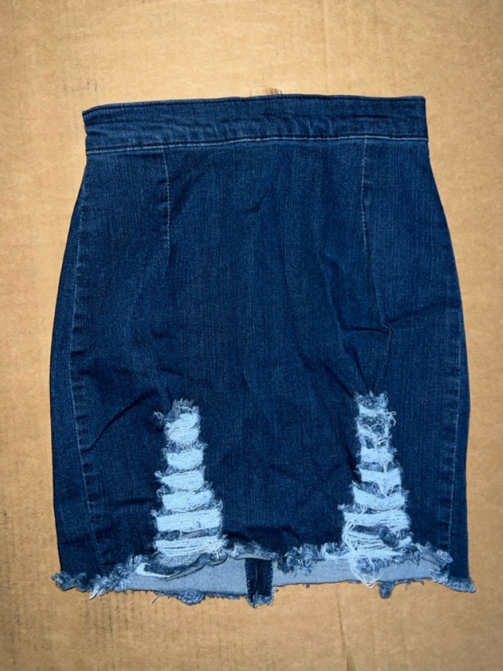Dark wash denim mini skirt with frayed hem and zipper